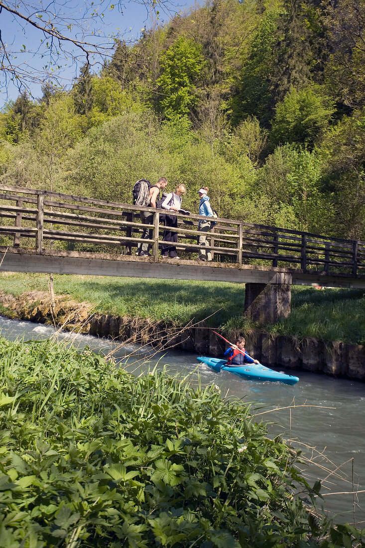 Man boating in river and people watching at Nature Park, Franconia, Switzerland