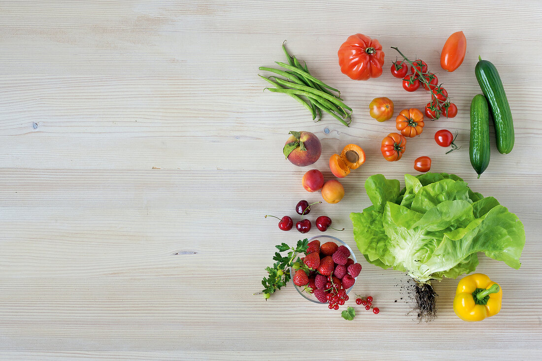 Different types of vegetables on wooden surface, overhead view