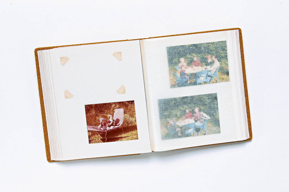 Photo album with family pictures and one photo removed on white background