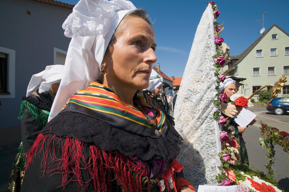 Woman in traditional wear performing rituals in Franconian Switzerland, Bavaria, Germany