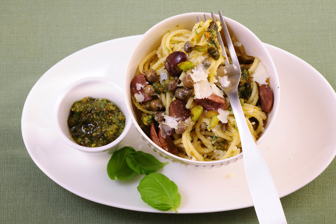 Spaghetti with pistachio pesto in bowl on plate