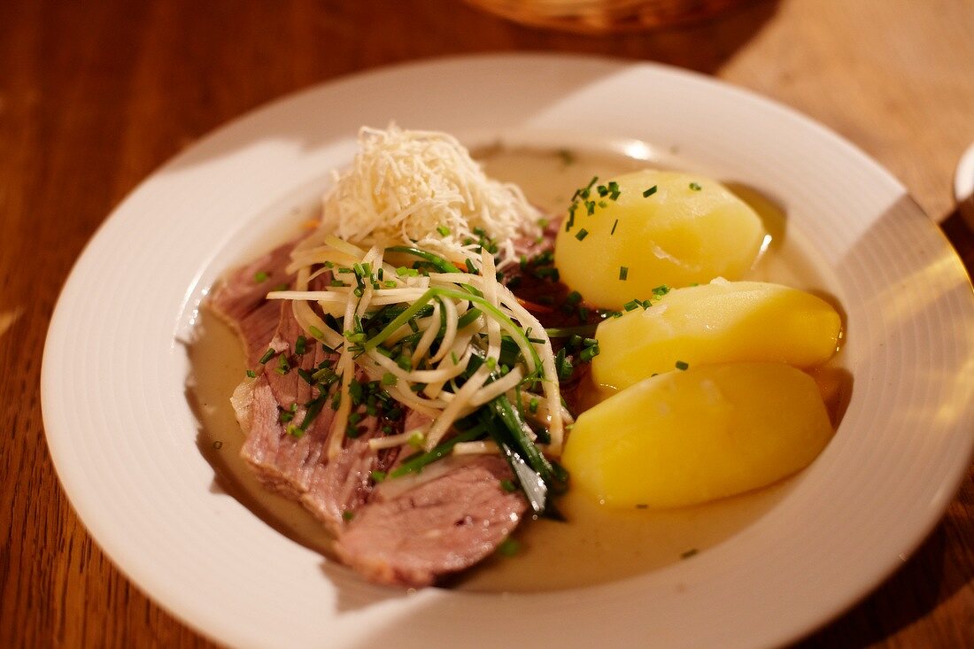 Munich, potatoes, radish and meat on plate