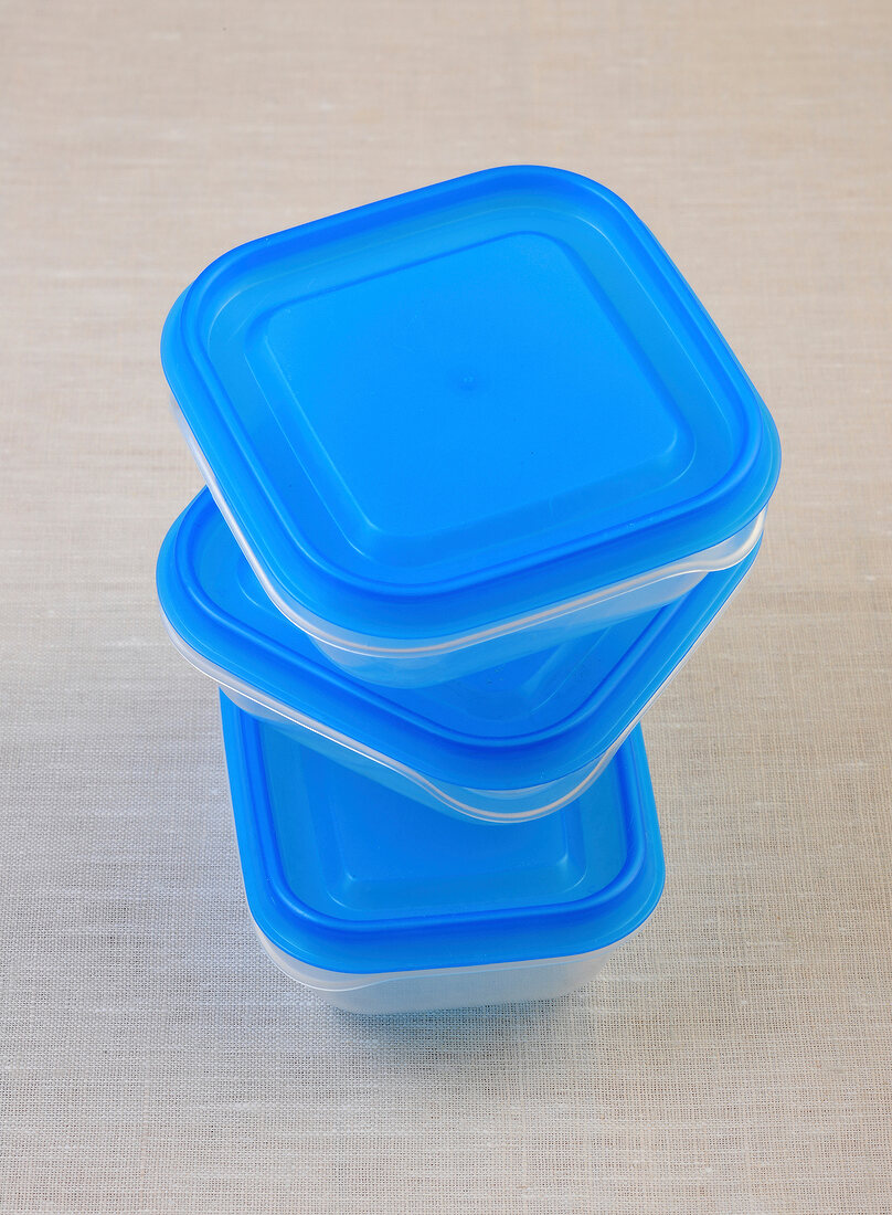 Stack of blue storage boxes on white background