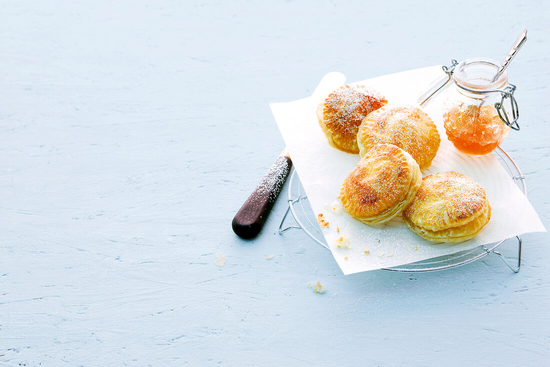 Jam tarts with butter paper on wire coaster