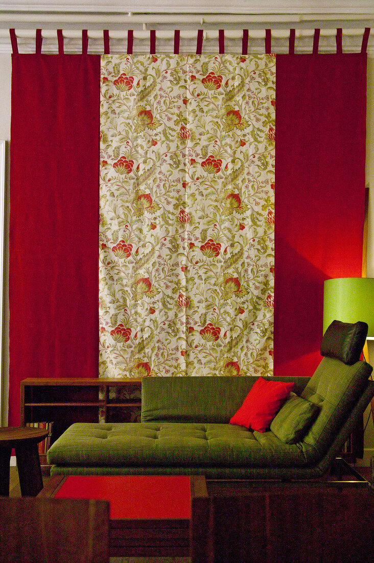 Close-up of resting sofa against patterned curtains