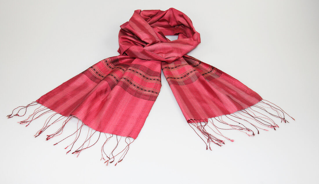 Red and pink plaid scarf on white background