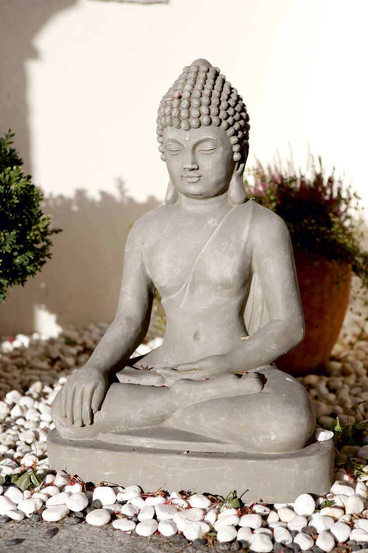 Statue of Buddha on pebbles