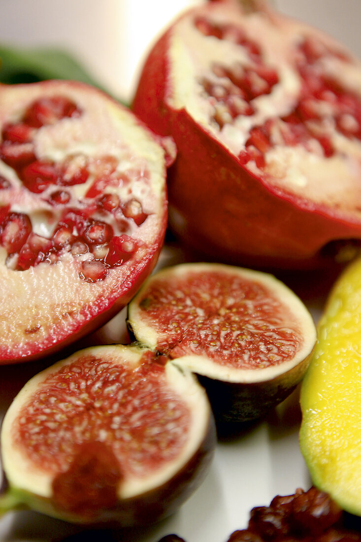 Close-up of halved pomegranate and fig