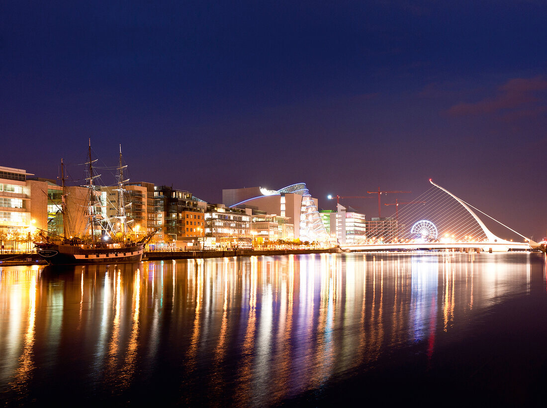 View of illuminated Samuel Becket Bridge at night, Dublin, Ireland, UK