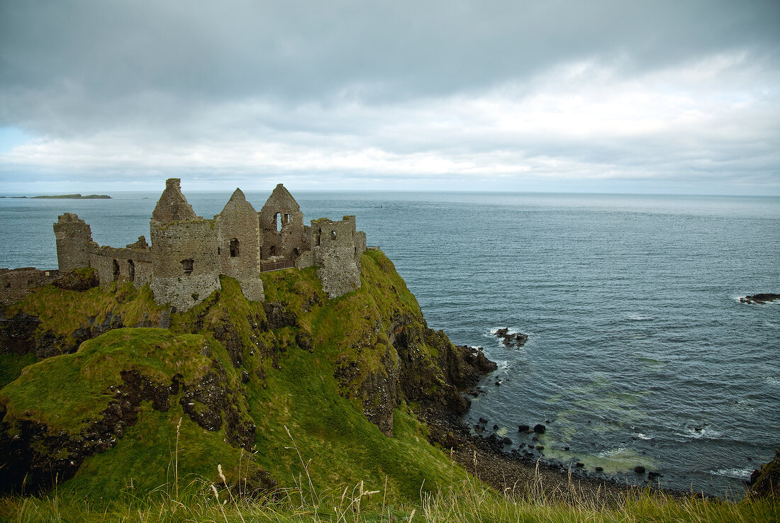 View of Dunluce Castle and Atlantic Ocean in Ireland, UK