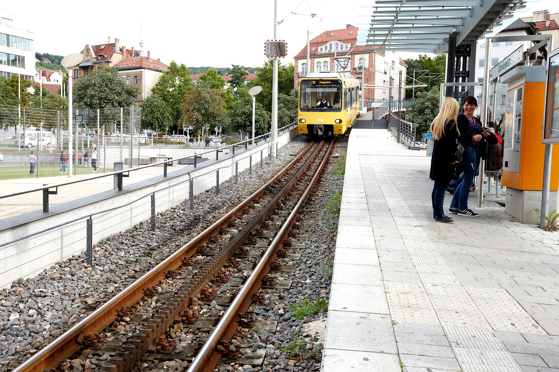 Two woman standing at Zacketse railway station in Stuttgart, Germany