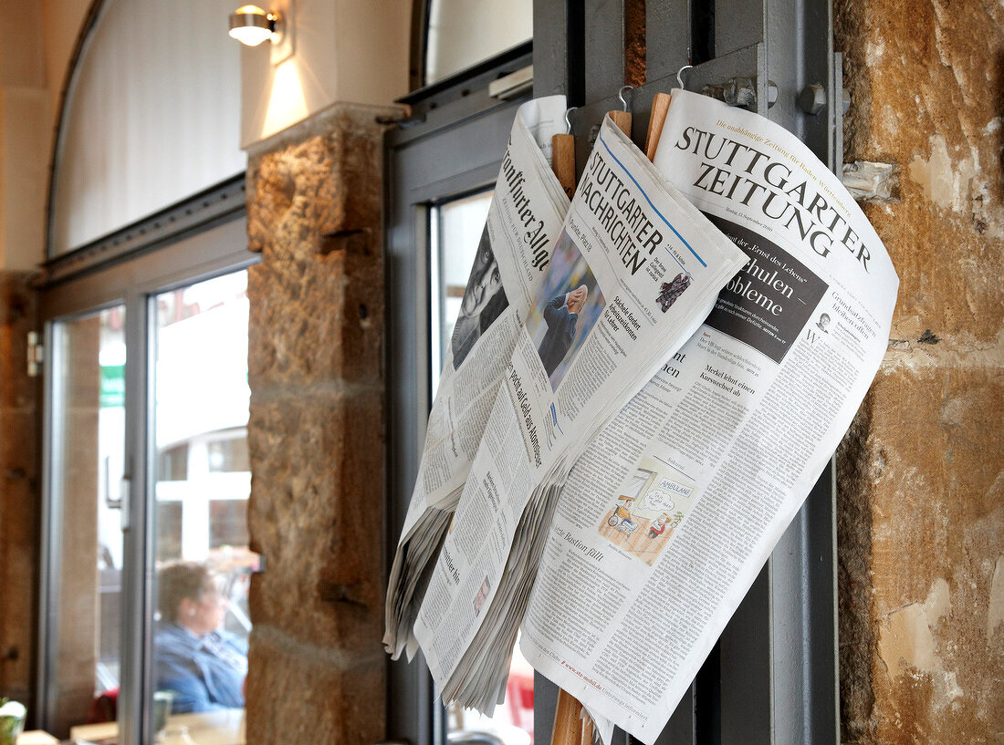 Newspapers hanging on wall of Deli restaurant in old town of Stuttgart, Germany
