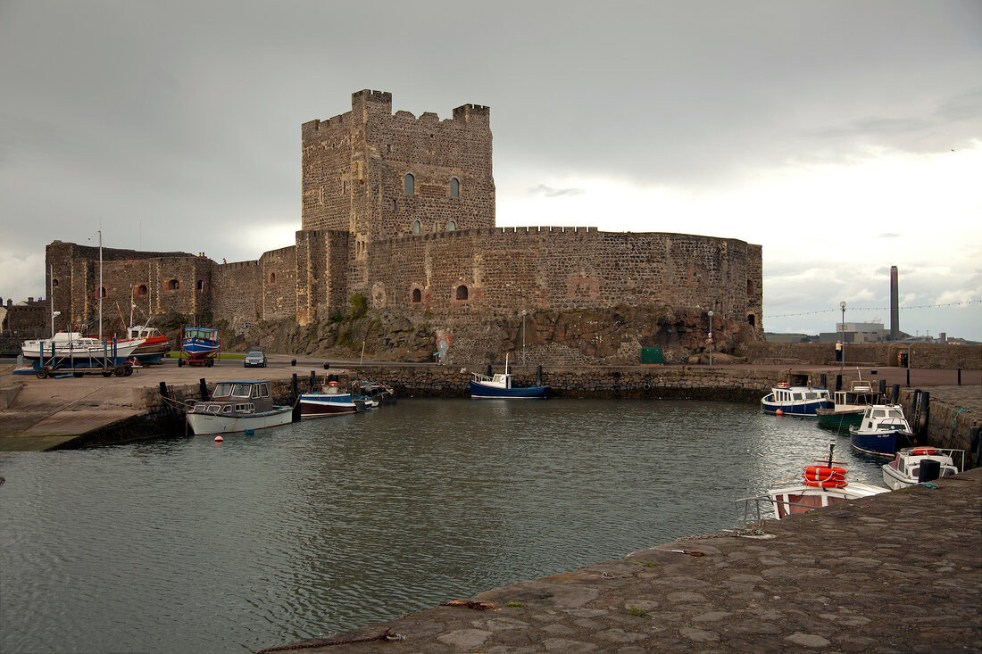 Boats moored at harbour in front of Carrickfergus Castle, Carrickfergus, Ireland