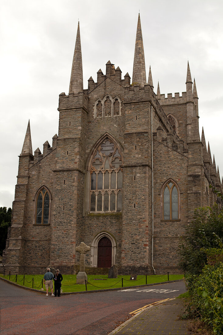 People standing in front of facade of Clonard Monastery in Belfast, Ireland