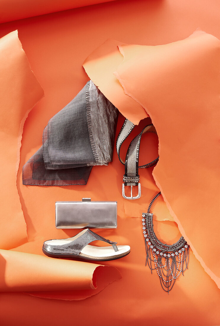 Shoe, scarf, belt and jewellery in marrakech style on orange background