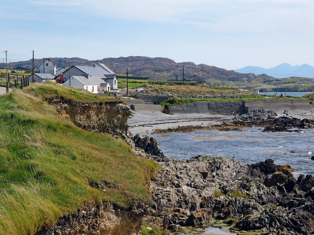 View rocky coast and houses in Inishbofin, Ireland