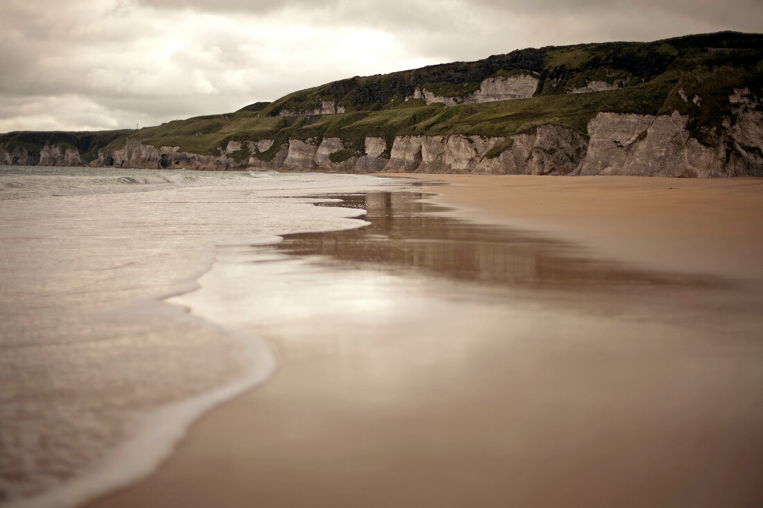 View of Antrim coast beach and sea in Ireland, UK