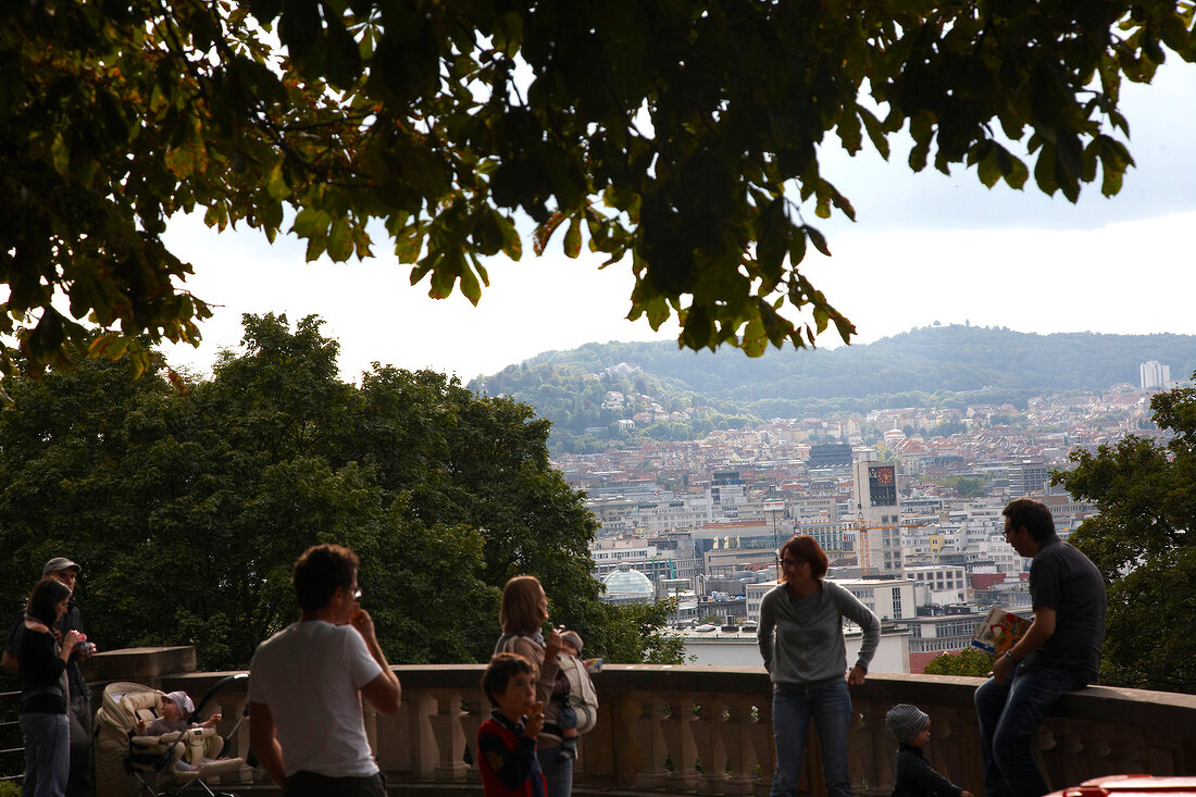 View of city of Stuttgart overlooking tourists standing on Eugensplatz, Germany