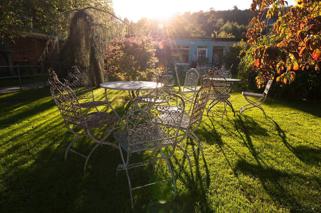 Table and chairs in Mount Usher Garden, Ashford, Ireland, UK