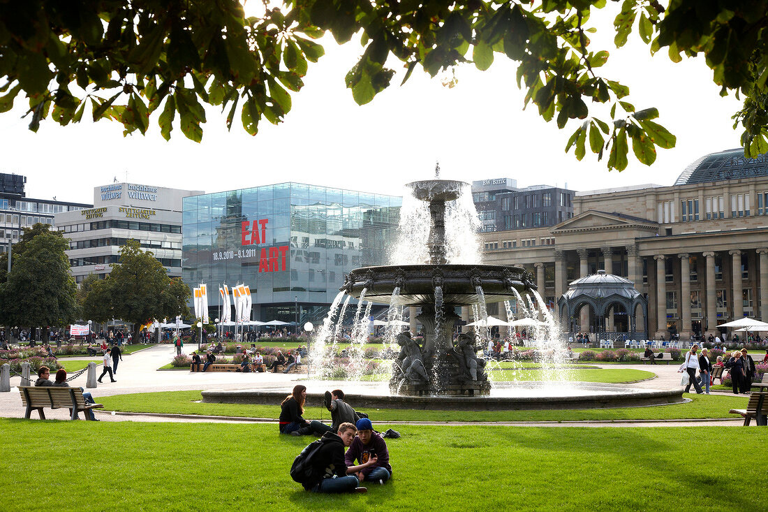 People sitting near springrunnen at Schlossplatz in Stuttgart, Baden-Wurttemberg, Germany