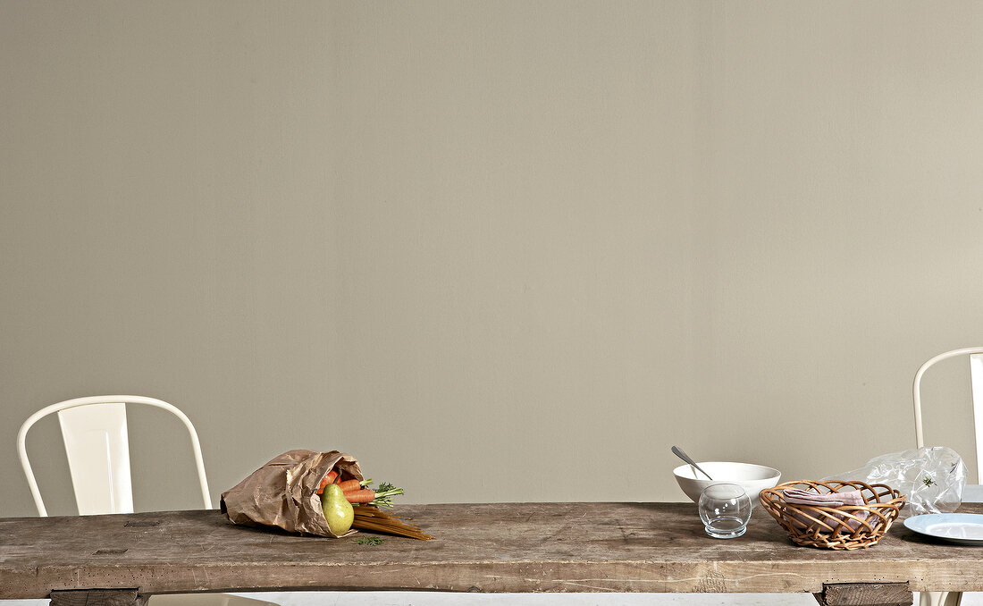 Paper bag with vegetables and fruits on a wooden table