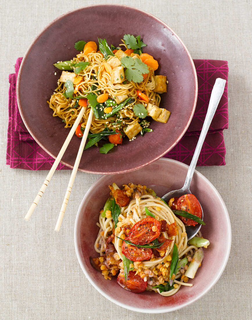 Noodles with fried tofu and spaghetti with red lentils in bowls