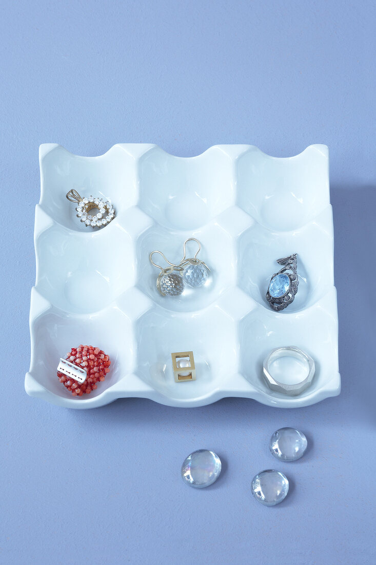 Egg cups converted to jewellery storage in white