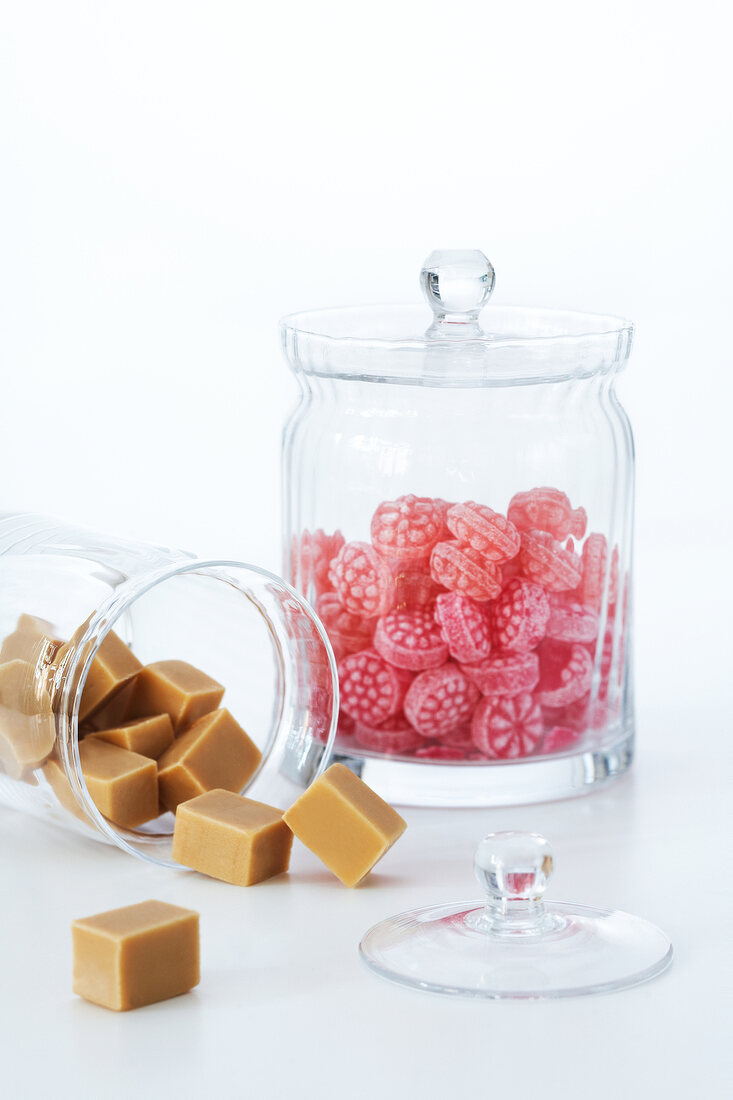 Glass jar filled with square and round shaped candies