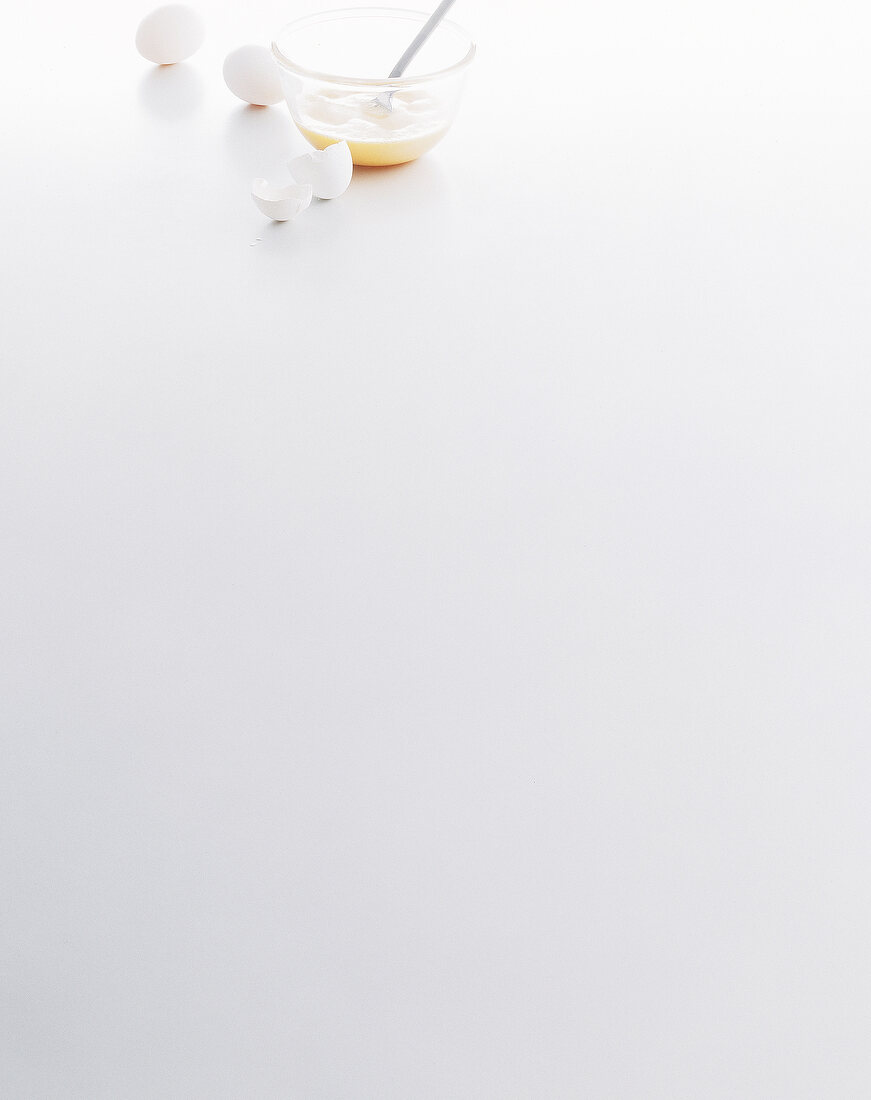 Eggs and egg shells on white background