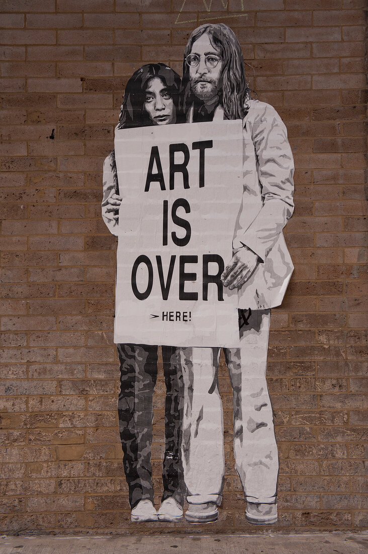 Painting on wall of John Lennon Yoko Ono with message written on it at New York, USA