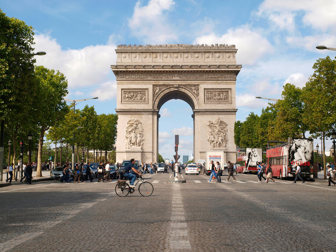 People walking in front of Arc de Triomphe on Place Charles de Gaulle in Paris, France