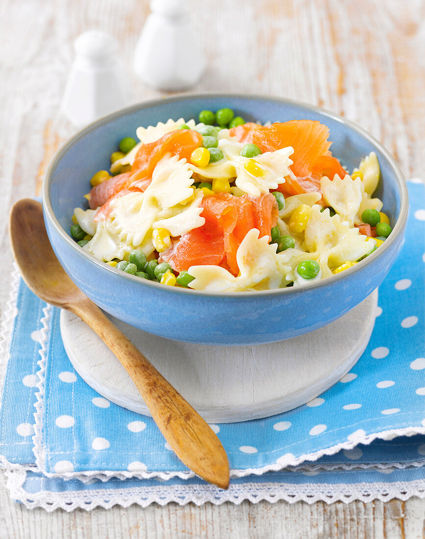 Farfalle pasta with peas and smoked salmon in bowl, express cooking