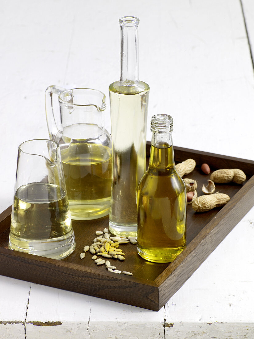 Various edible oils in glass bottles and carafes