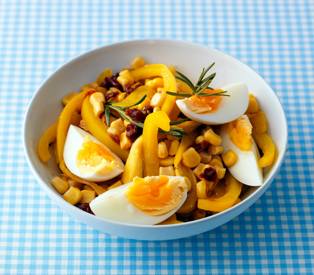Peppers and corn salad with hard-boiled eggs in bowl
