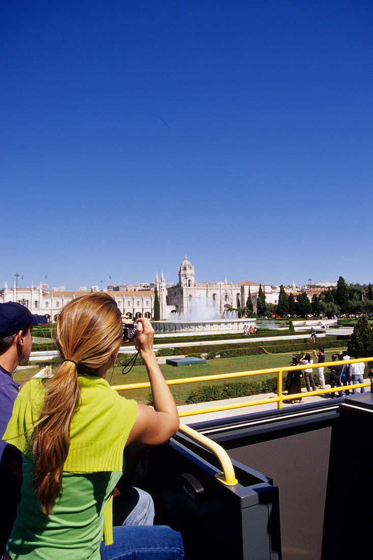 Tourist photographing Praca do Imperia in Lisbon, Portugal