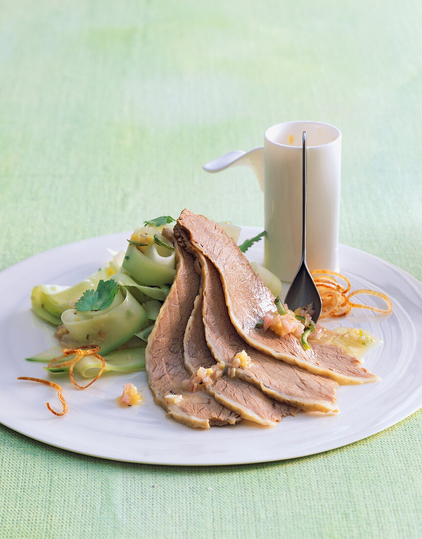 Boiled veal with papaya salad and vinaigrette on plate