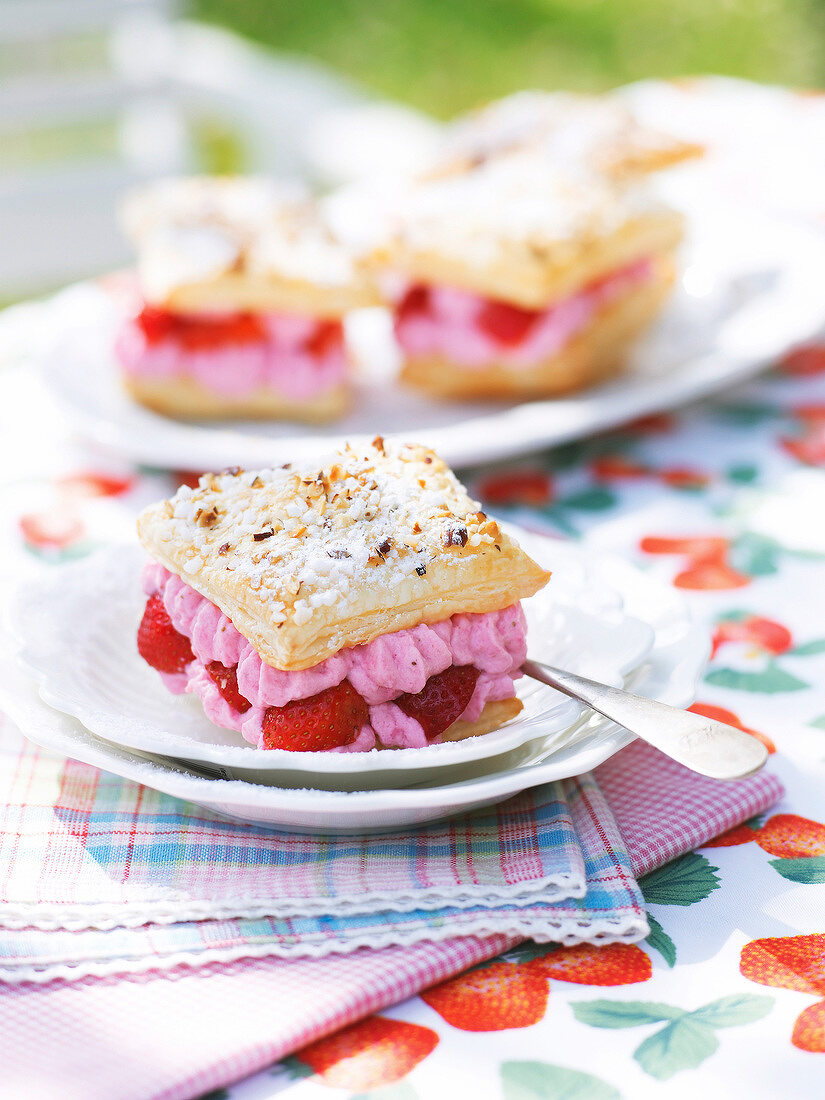 Airy cottage cheese with strawberry filling on saucer in summer kitchen