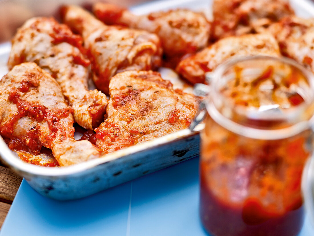 Close-up of marinated chicken wings in baking dish