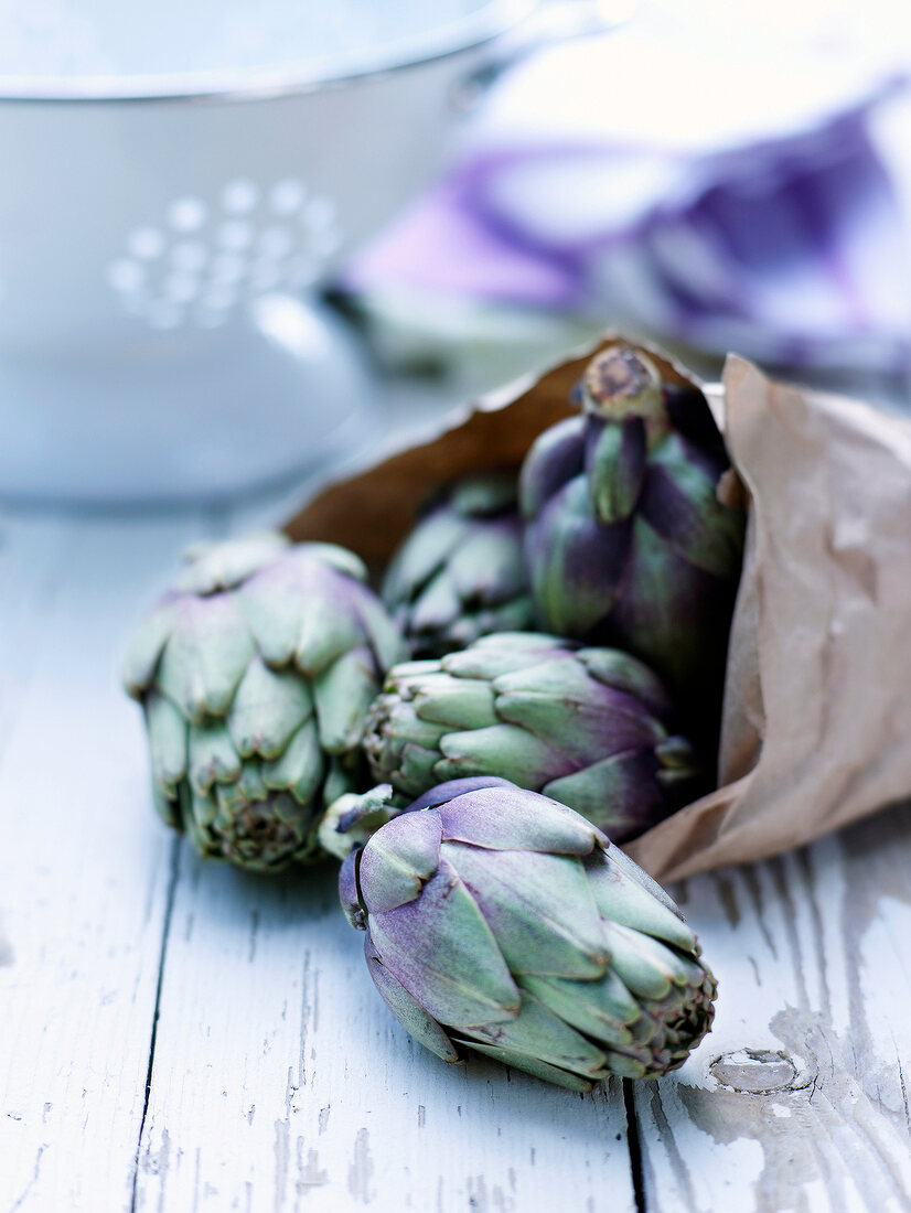 Close-up of artichokes on wood