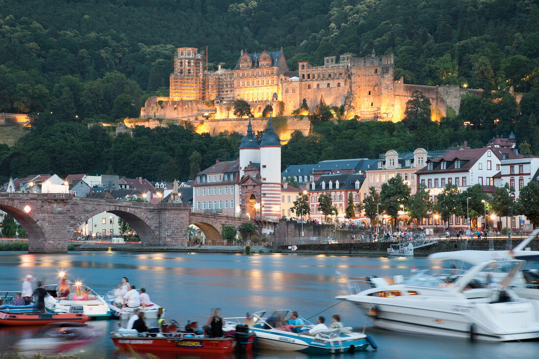 View of people in boat and Karl-Theodor Bridge at evening, Heidelberg, Germany