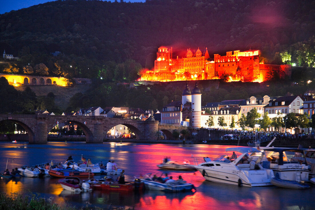 View of people in boat and Karl-Theodor Bridge at evening, Heidelberg, Germany