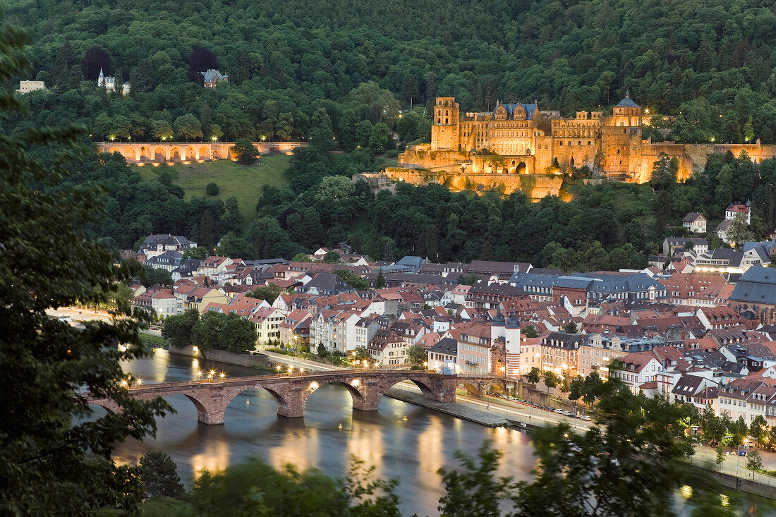 View of illuminated Karl Theodor Bridge and Castle at night in Heidelberg, Germany