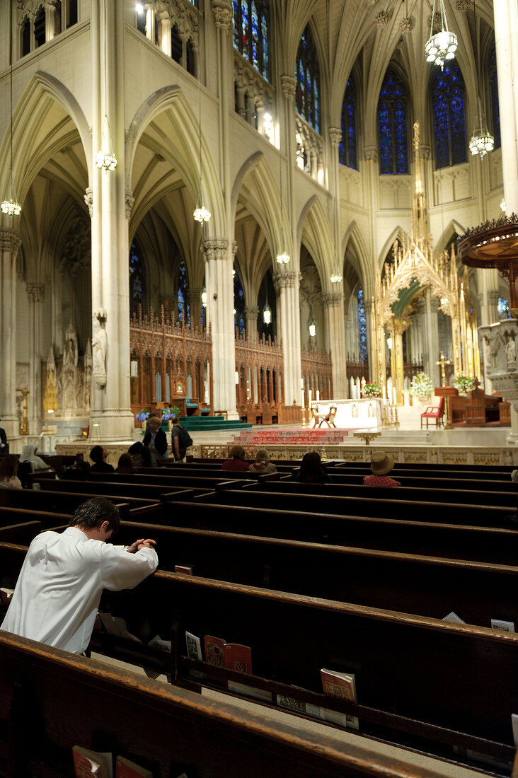 People attending mass at St. Patrick's Cathedral in Fifth Avenue, New York, USA