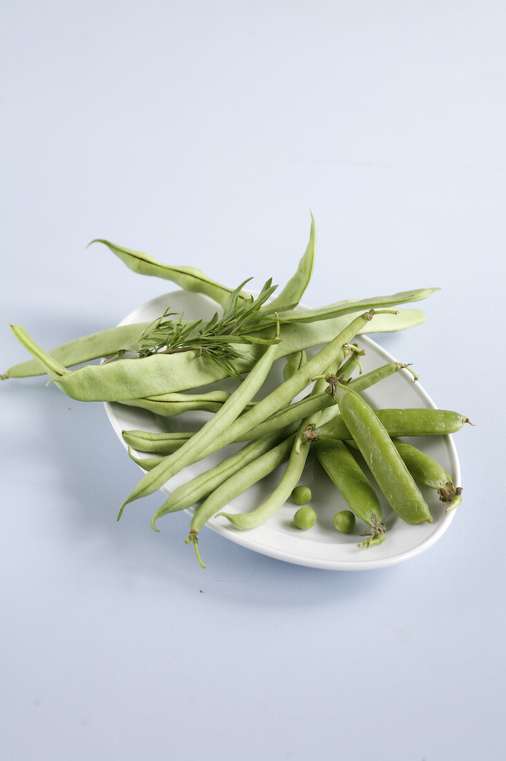 Snow peas, peas and beans on white background