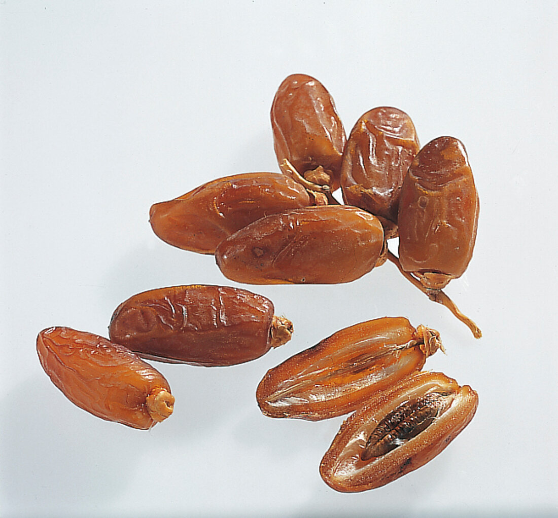 Dried dates on white background