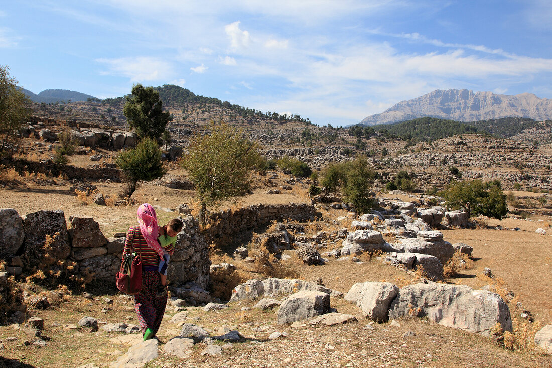 Villager walking through karst rock formations in Selge, Pisidia, Antalya, Turkey