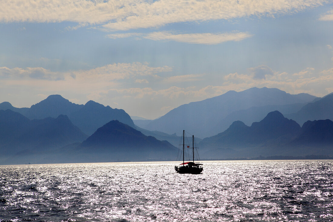 View of mountains and boat in sea at Antalya, Turkey