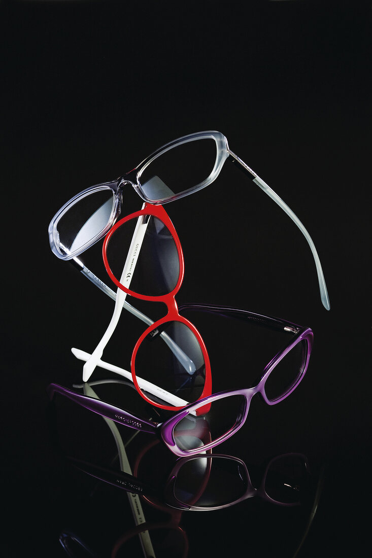 Various eyeglass frames on black background