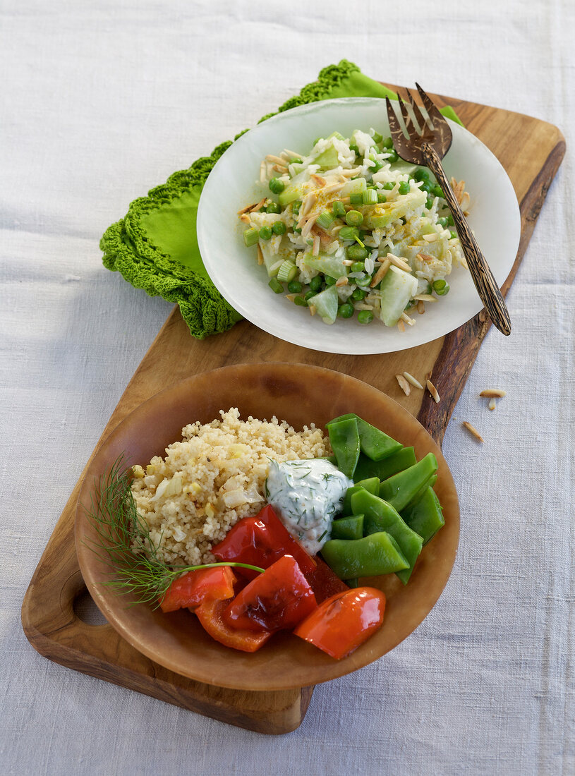 Curried rice salad and couscous vegetables salad on plates