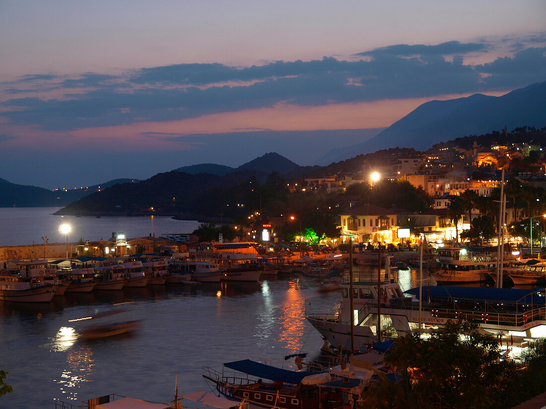 View of boats moored in harbour at sunset, Kas, Lycia, Antalya, Turkey